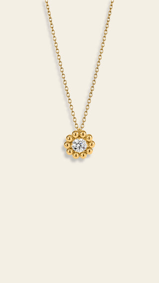 Daisy riipus kirkkaalla kivellä, keltakullattua pronssia